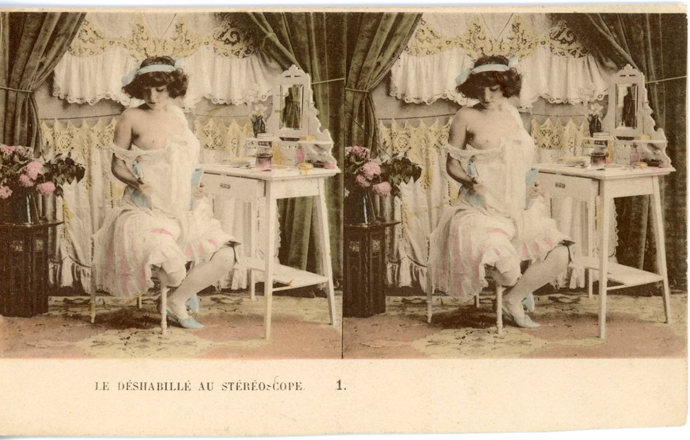 Image of a rectangular stereo photograph showing risqué image of partially dressed woman