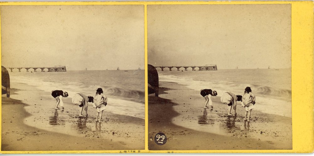 Image of a rectangular stereo photograph showing risqué image of partially dressed woman