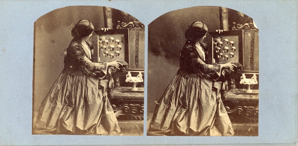 Image of a rectangular stereo photograph showing risqué image of partially dressed woman